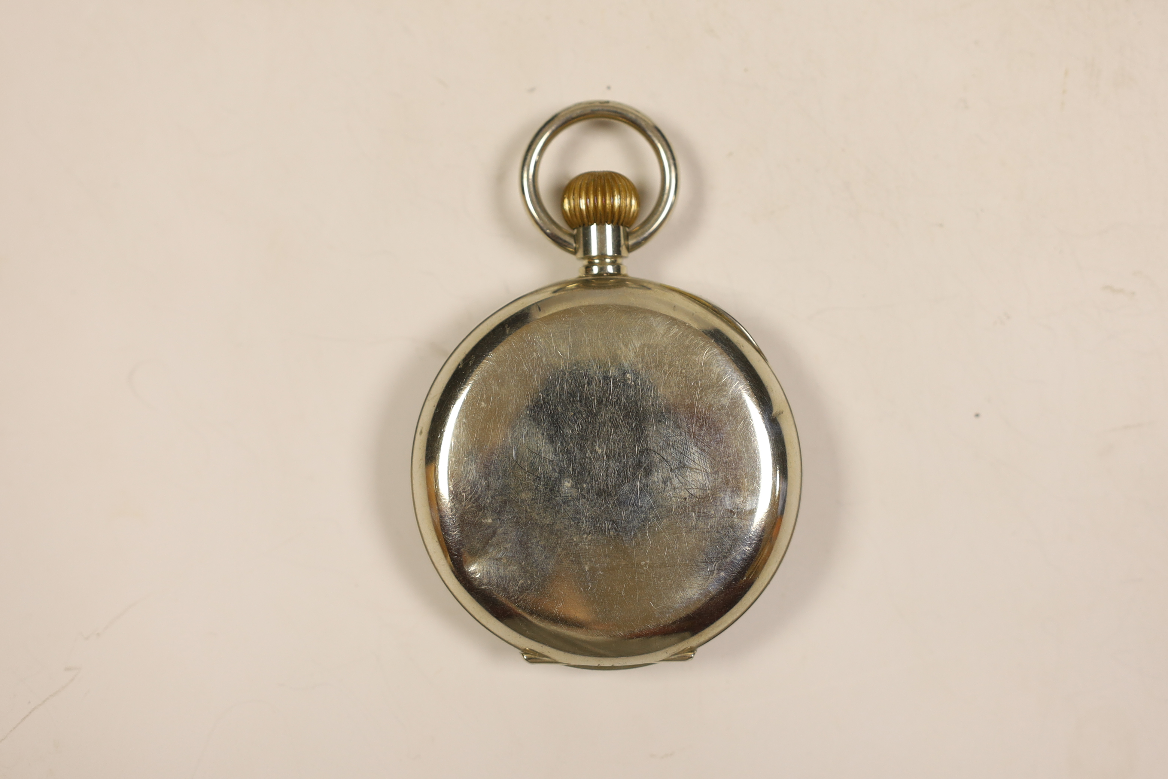 A vintage 'Goliath' pocket watch housed in an Edwardian hammered silver bedside watch stand by William Comyns, London, 1902, 11cm.
